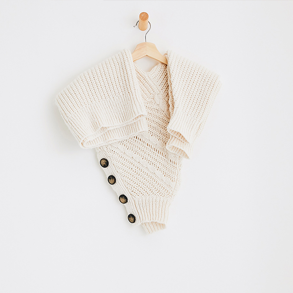 An Aerie sweater draped over a hanger.