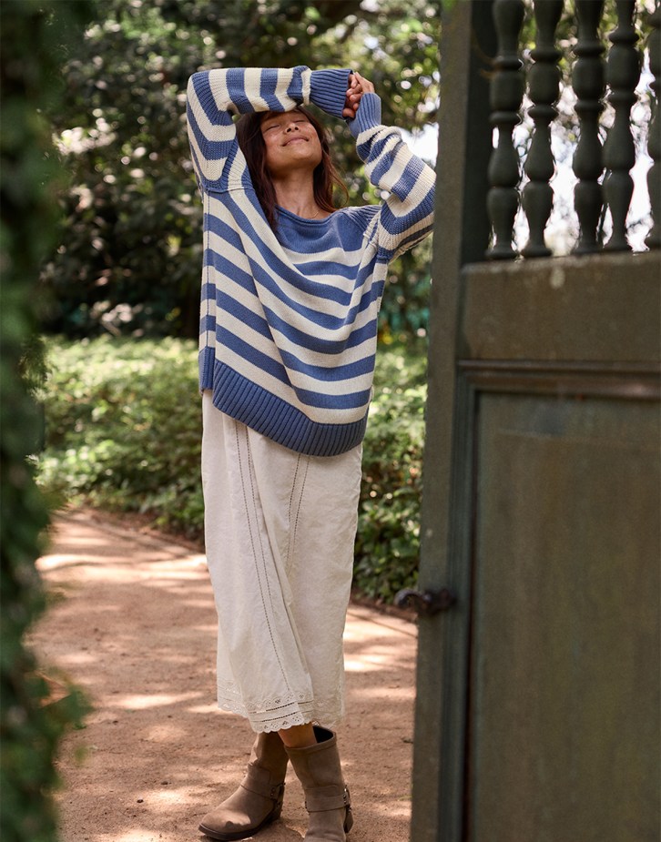 Women's fall outfit featuring striped sweater and long skirt.
