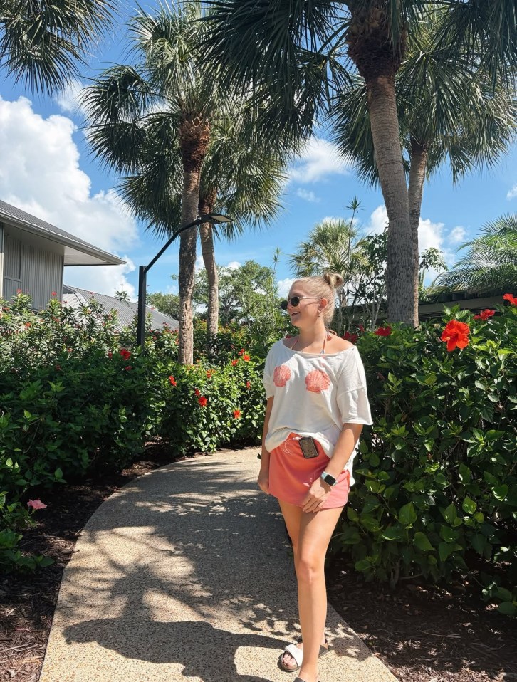 Woman wearing an Aerie top and orange shorts.