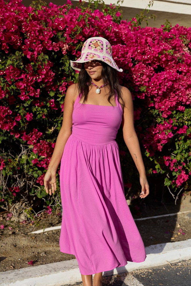 Woman wearing a pink maxi dress.