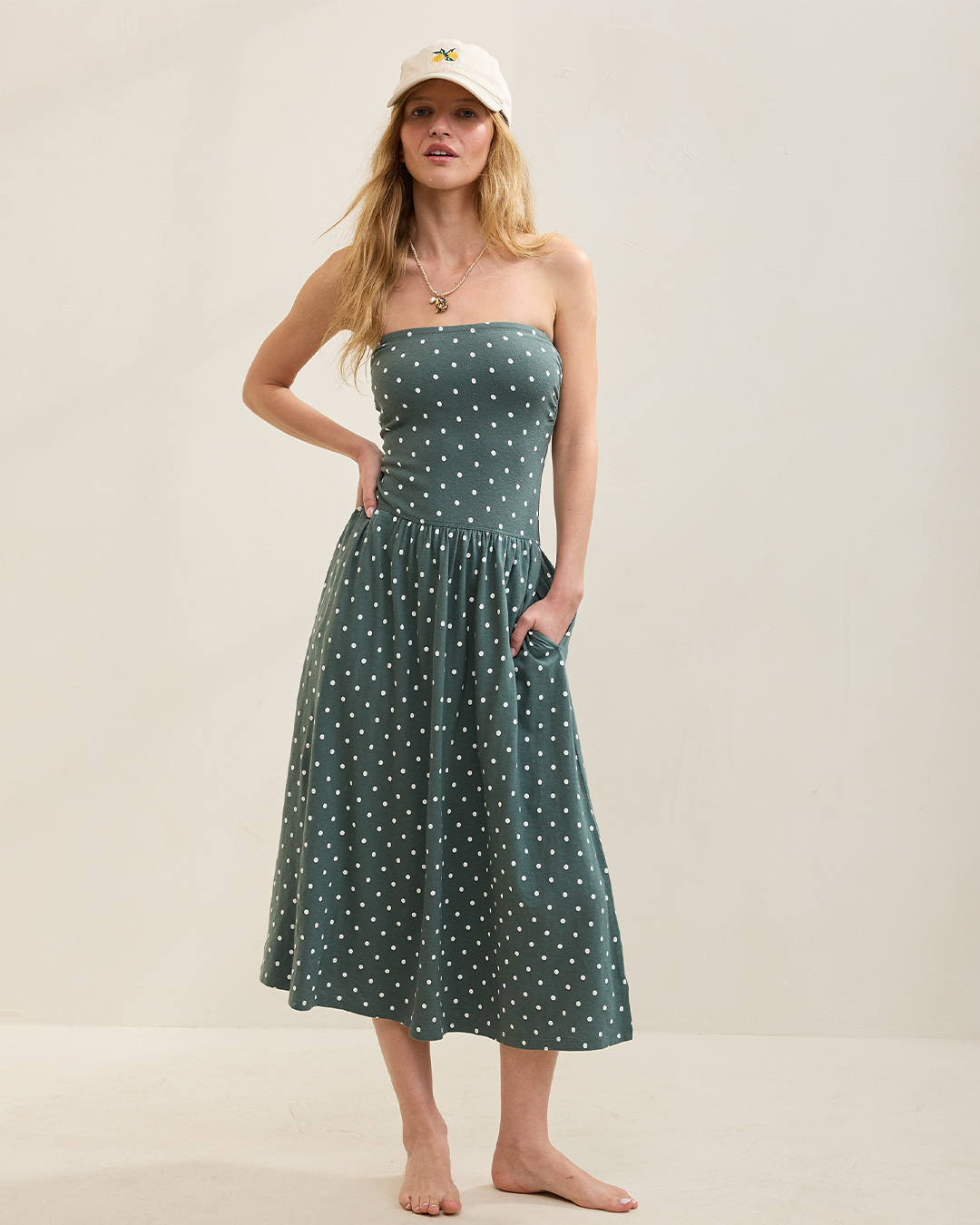 Woman wearing a polka dot maxi dress.