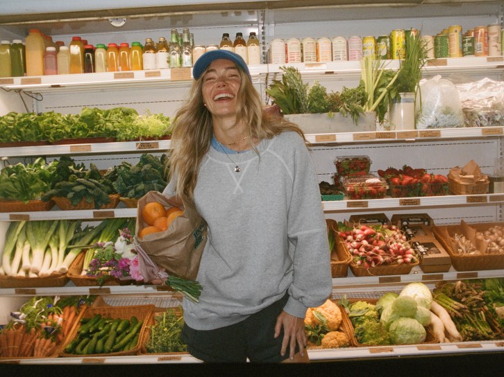 Woman in a store wearing an Aerie hoodie.