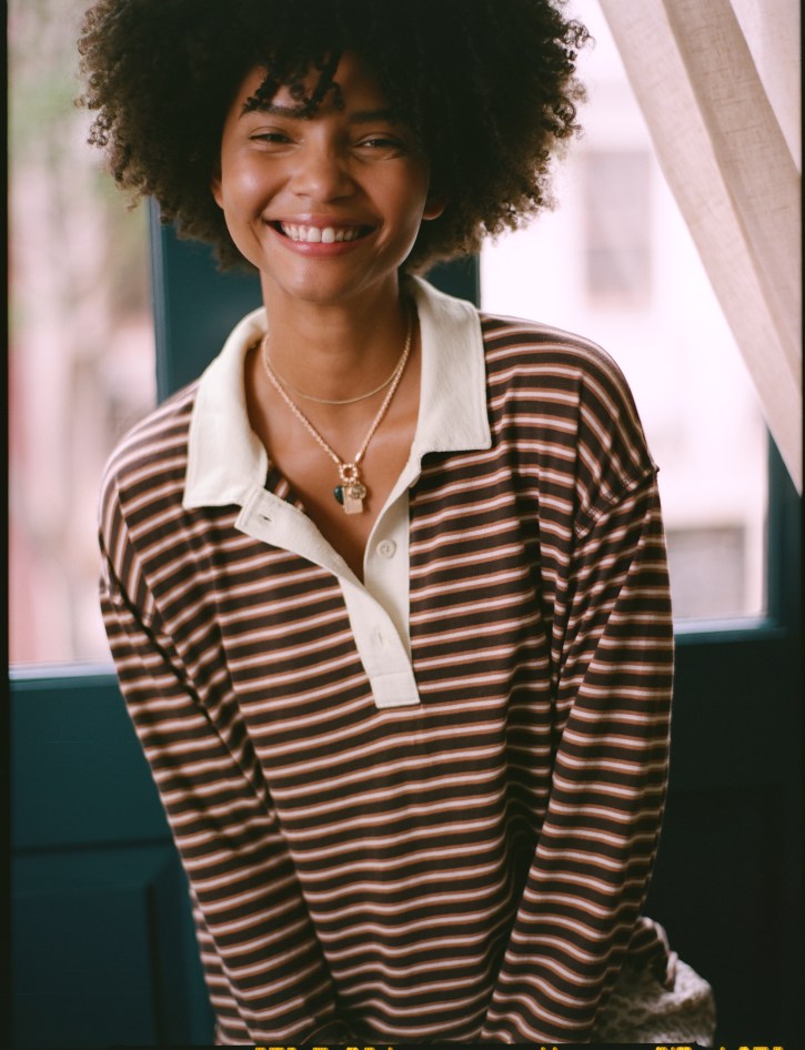 Woman wearing a striped henley top.