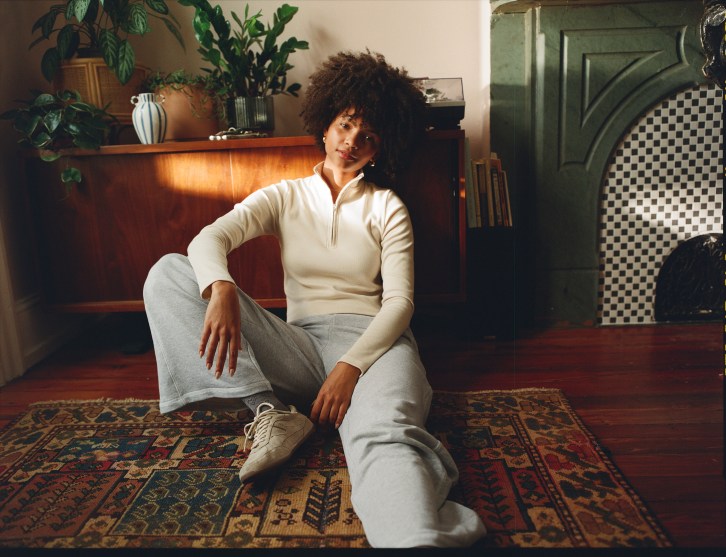 Woman wearing sweatpants and a cozy zip-up.