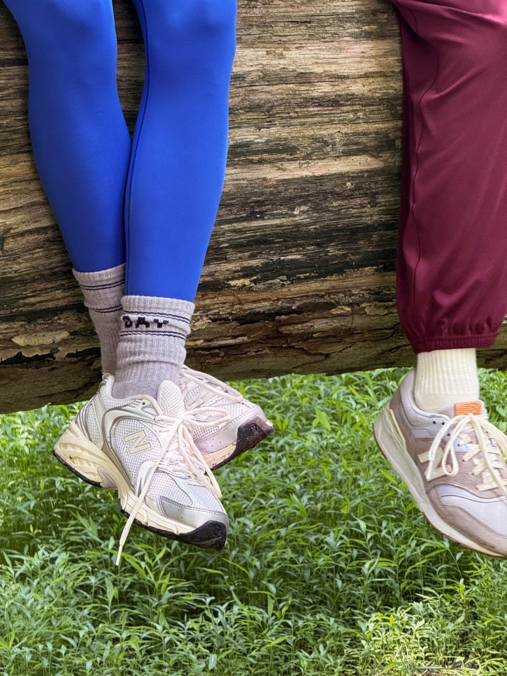 Women wearing blue and maroon leggings. 